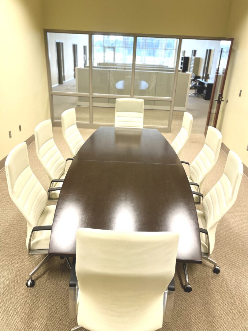 A conference room with chairs around the table.