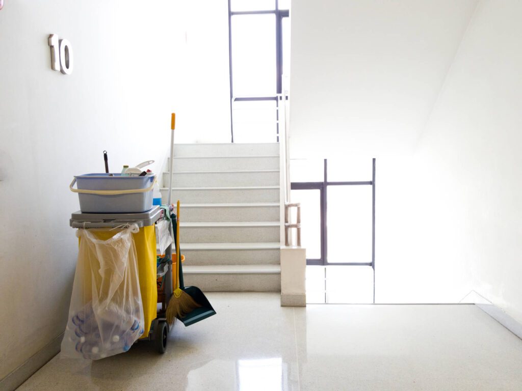 A room with a white floor and stairs