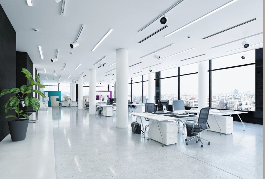 A large open office space with white walls and floors.