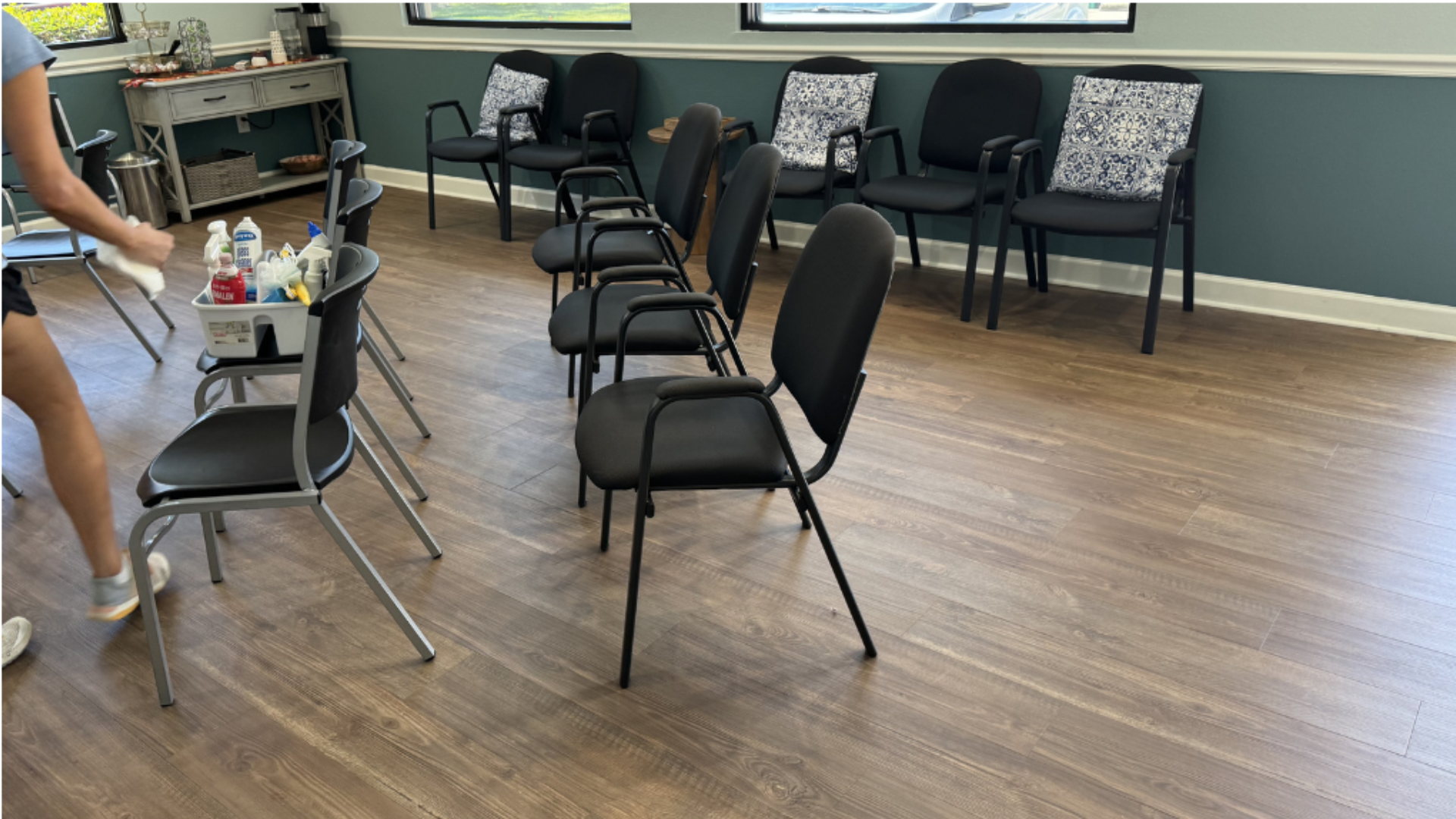 A employee for Gulf South Janitorial is wiping down chairs