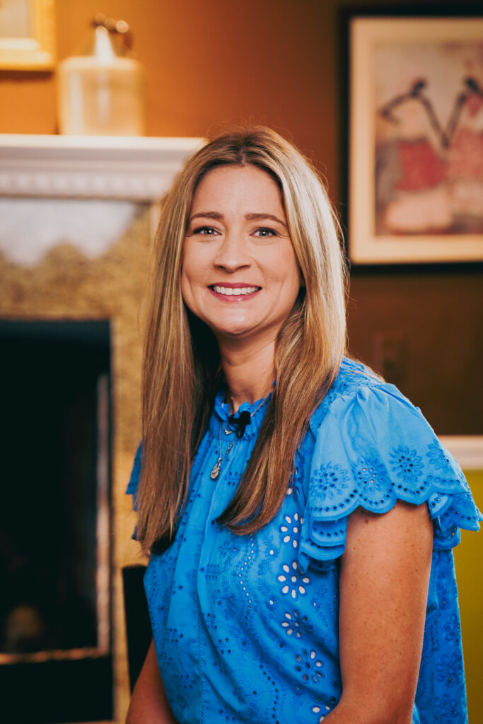 Portrait of the owner of Gulf South Janitorial, standing confidently in a professional uniform. The owner has a friendly smile, with short hair and a clean-cut appearance. They are in a well-maintained office space, with cleaning equipment and supplies in the background, showcasing their leadership in the janitorial industry