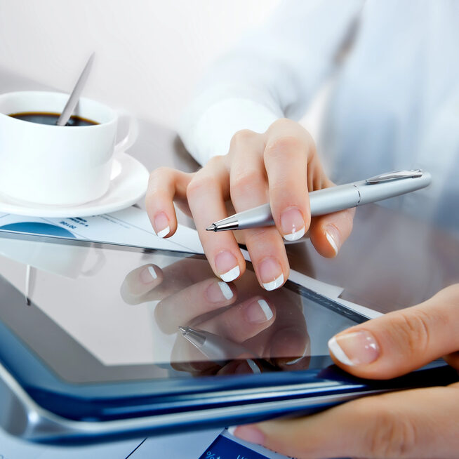 A person using a tablet to calculate a janitorial service quote