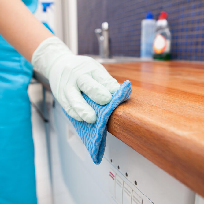 a gulf south janitorial employee cleaning a table