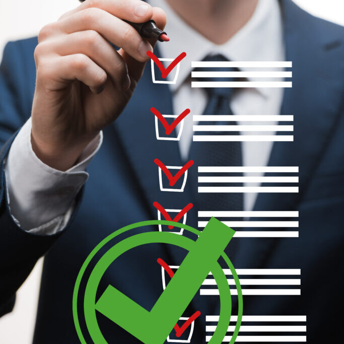 A man in a suit and tie writing a janitorial scope of work